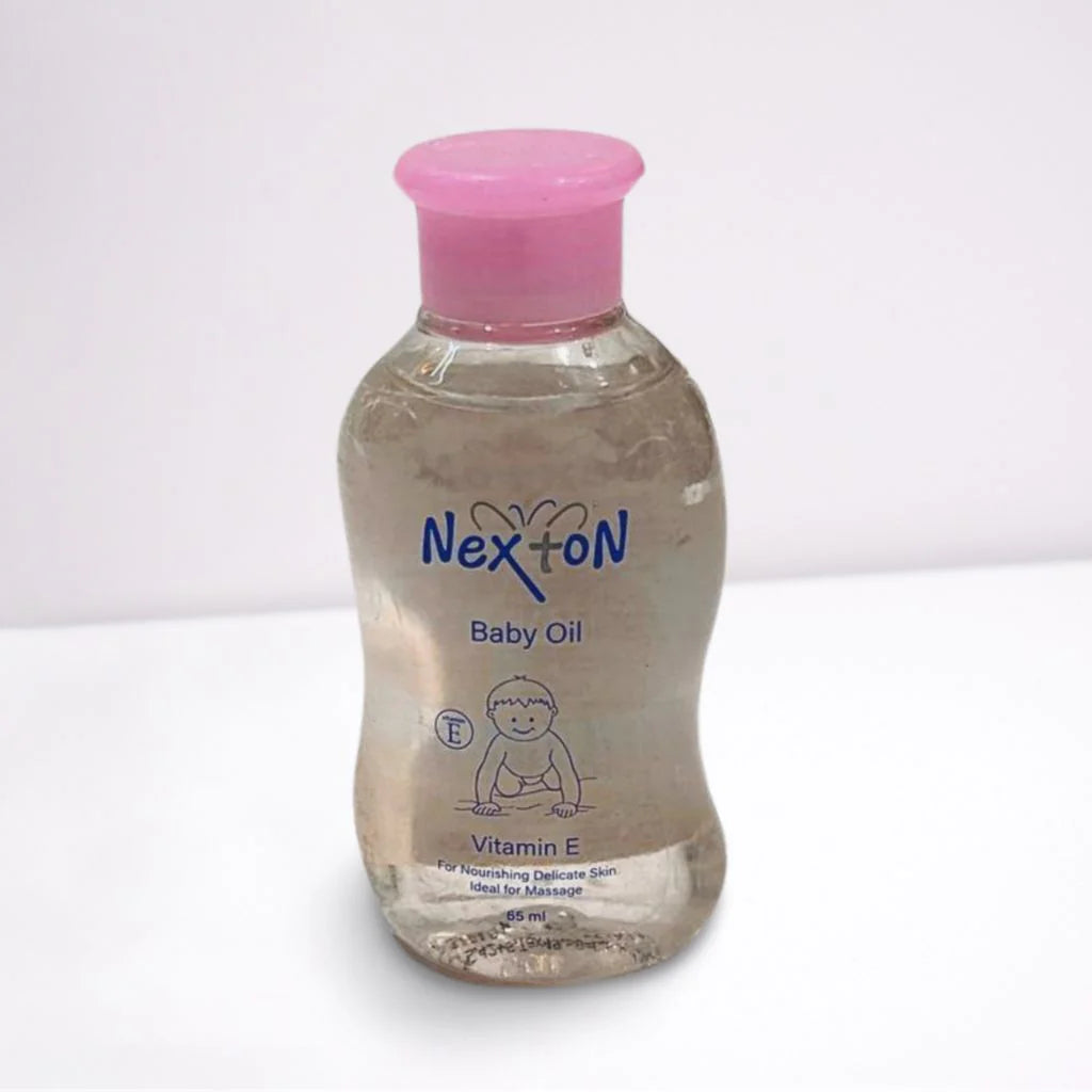Bottle of Nexton Baby Oil with a pink cap on a white background