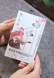 Person holding a box of RX3 Pro earphones with a tablet in the background

